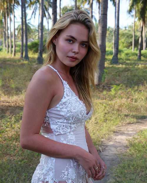 Lilly Van der Meer in plunging white dress